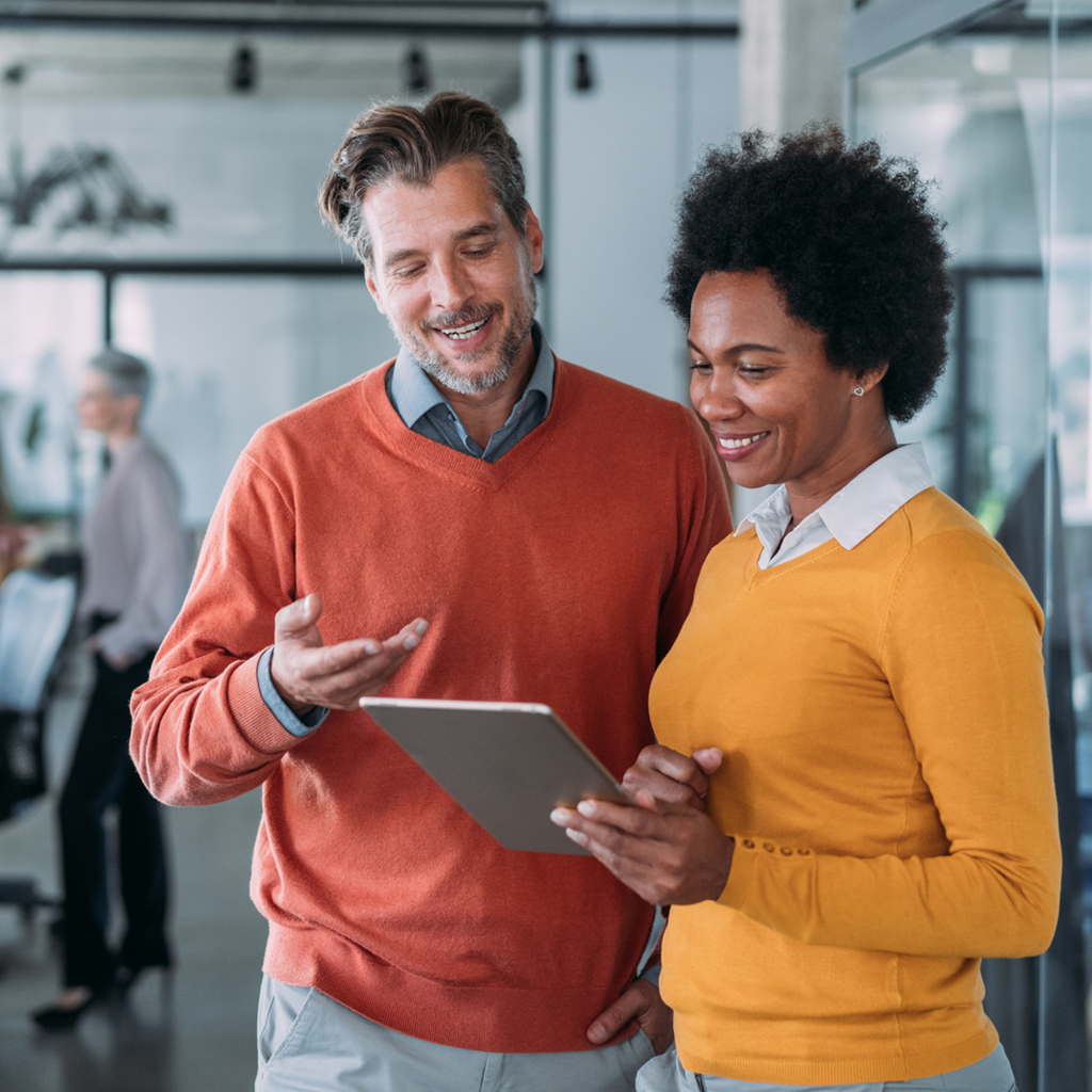 Business man and woman looking at tablet