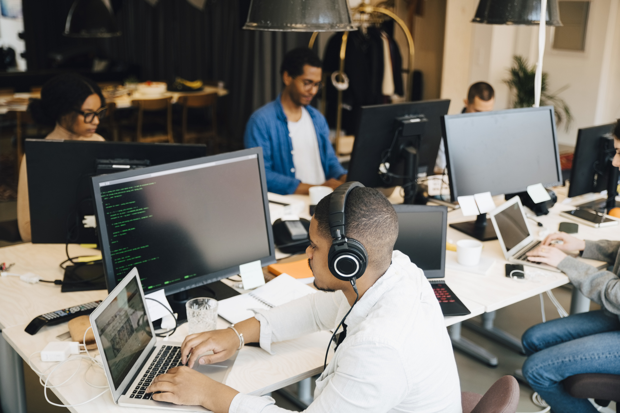 Co-workers working in office on code