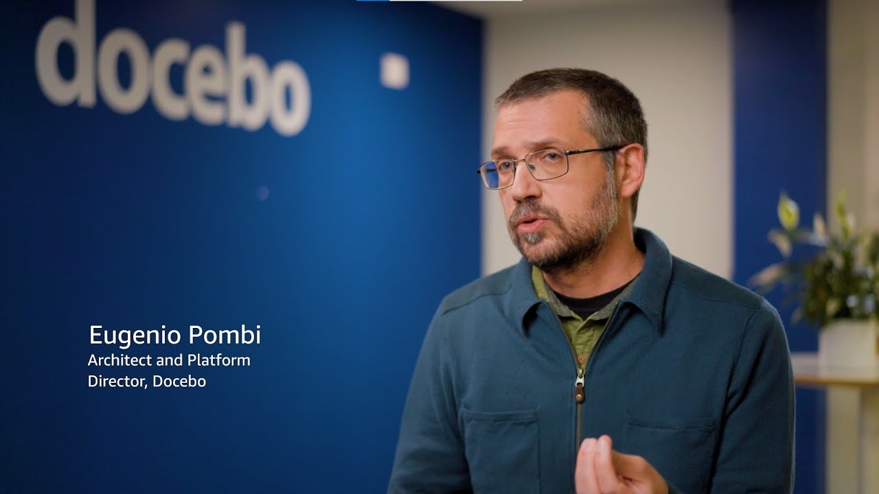 Text overlay reads "Eugenio Pombi, Architect and Platform Director, Docebo" against a blue background with the Docebo logo.