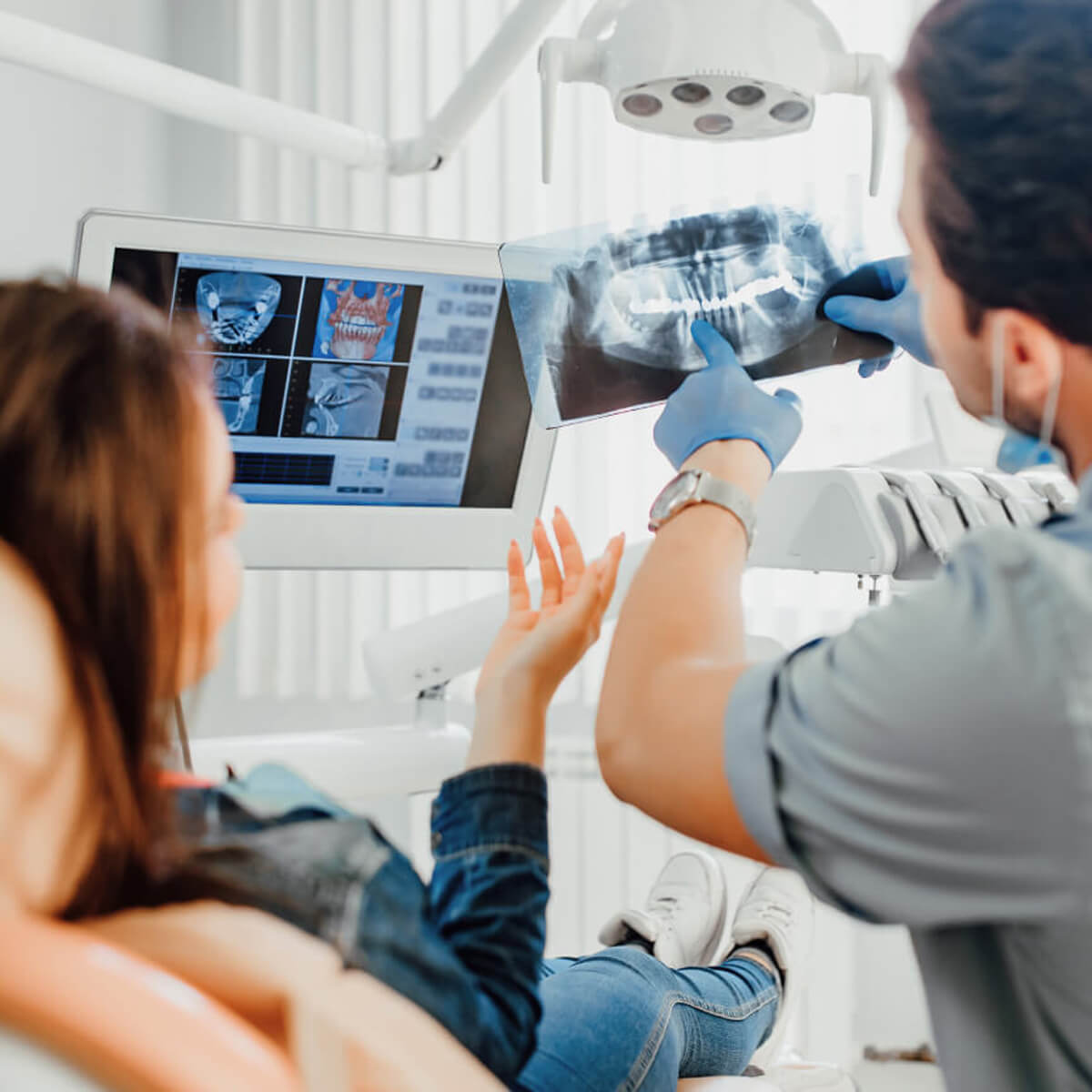 Dentist reviewing x-rays with patient