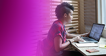 A woman sits at a desk working on a laptop, symbolizing the next evolution of application development. The image features a modern workspace with a focus on technology and innovation.