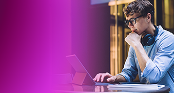 A focused professional works on a laptop at a desk, wearing headphones around the neck, symbolizing streamlining Amazon EKS operations. This image is used for a how-to guide related to Amazon EKS.