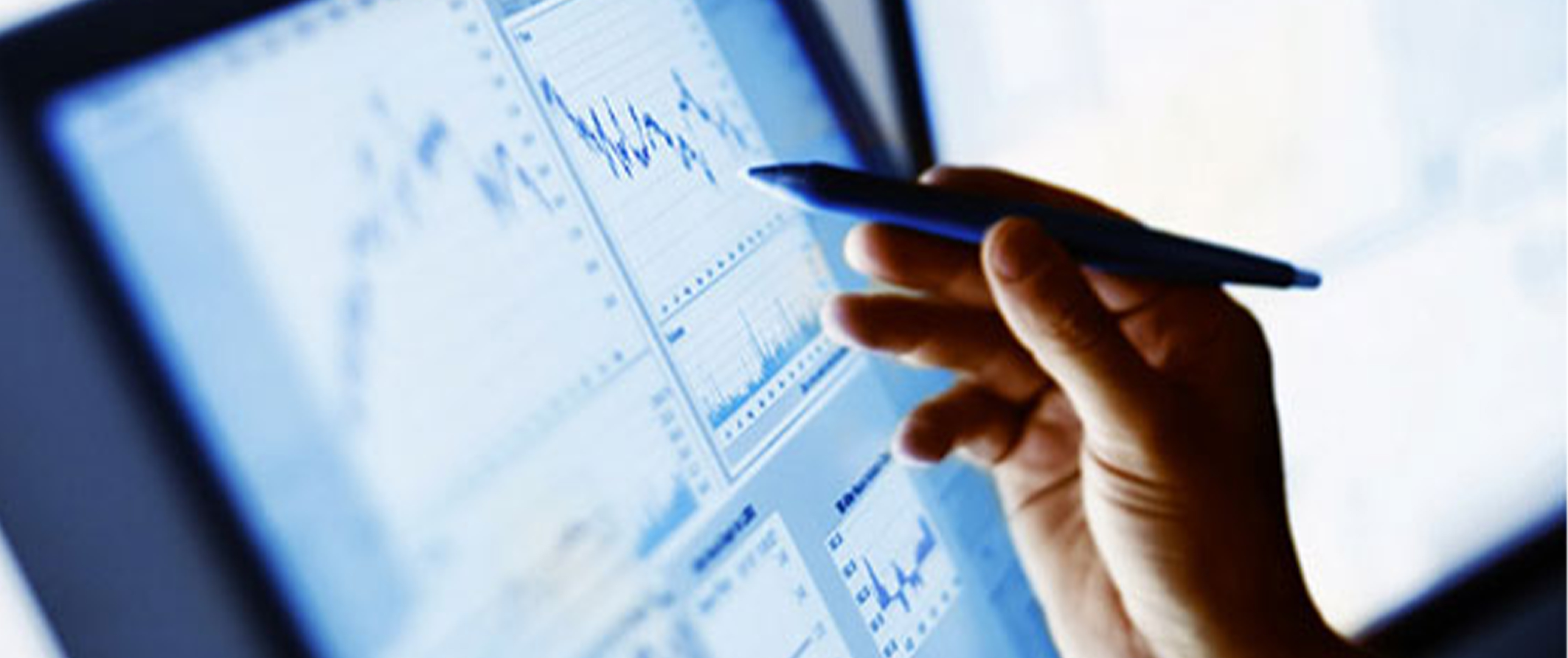 A close-up view of a hand using a pen on a digital tablet displaying medical diagnostic data and graphs, representing modern healthcare technology and data analysis.