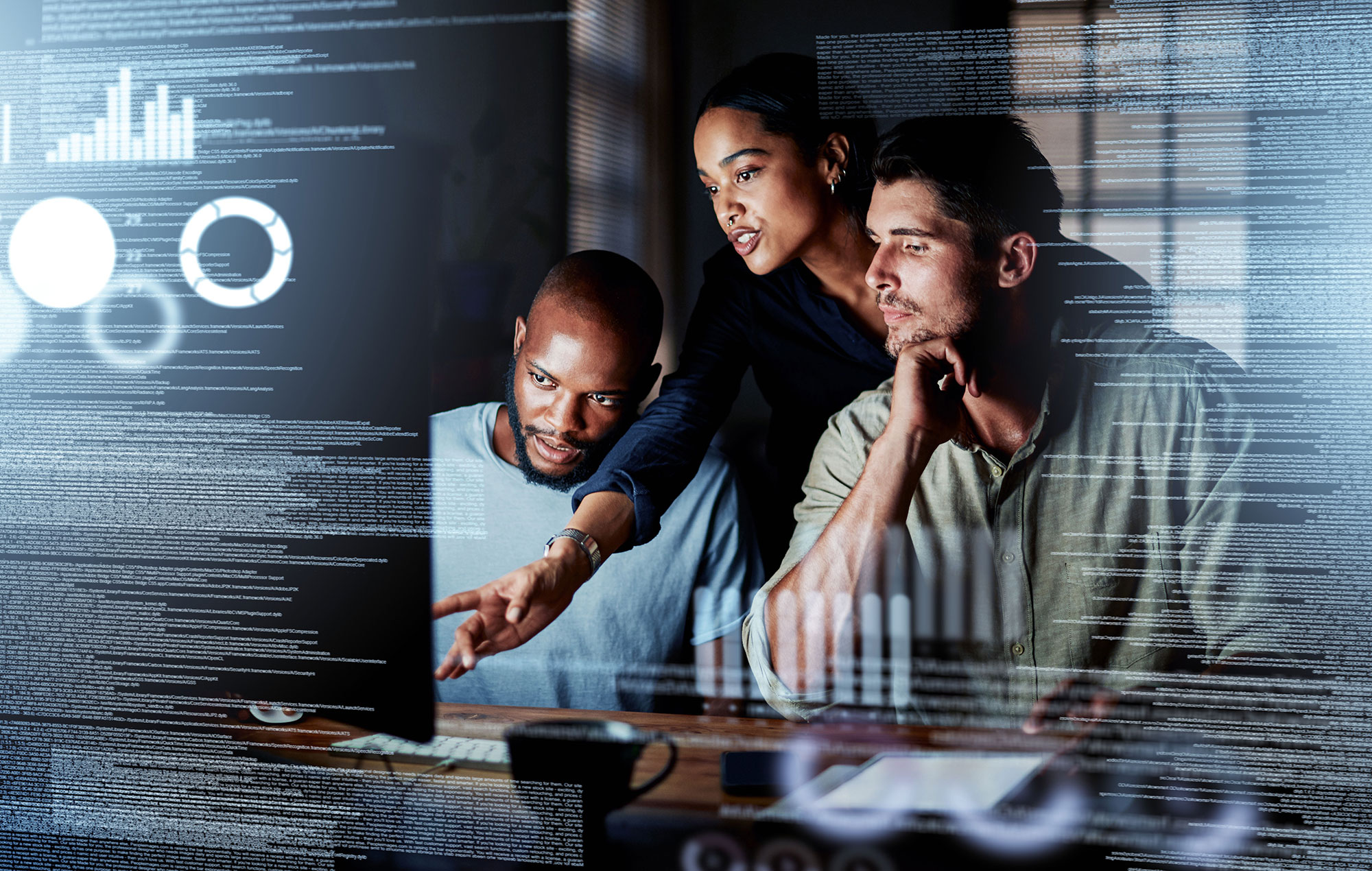 A group of people collaborating at a computer, with digital data and graphs overlaid on the image.