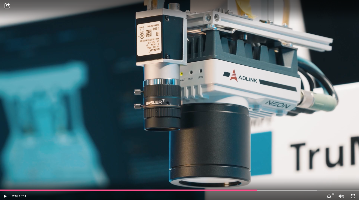 Close-up view of an ADLINK NEON industrial camera equipped with a Basler lens, showing electronic components and connection details.