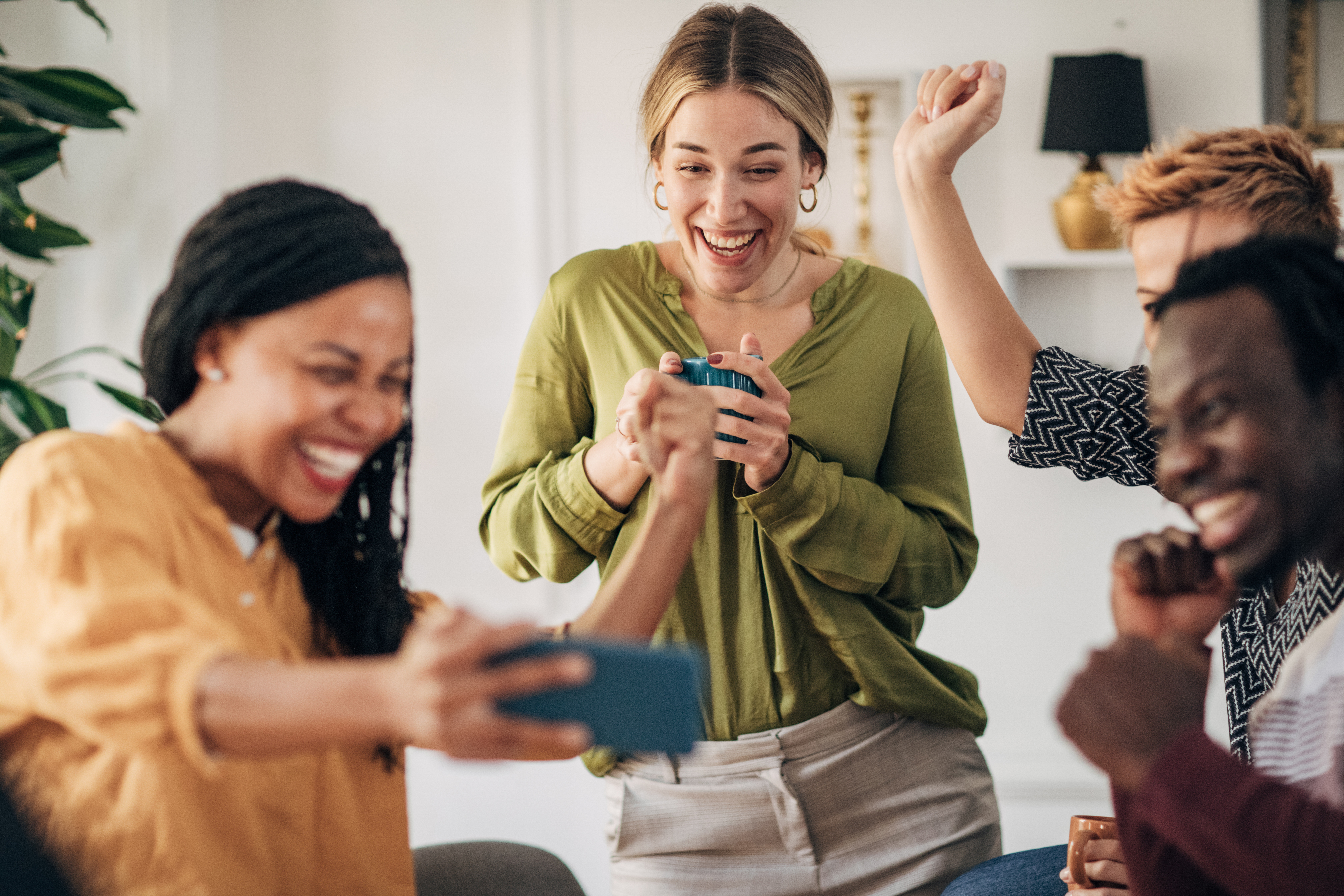 Group of friends watching live sport game on smart phone and cheering