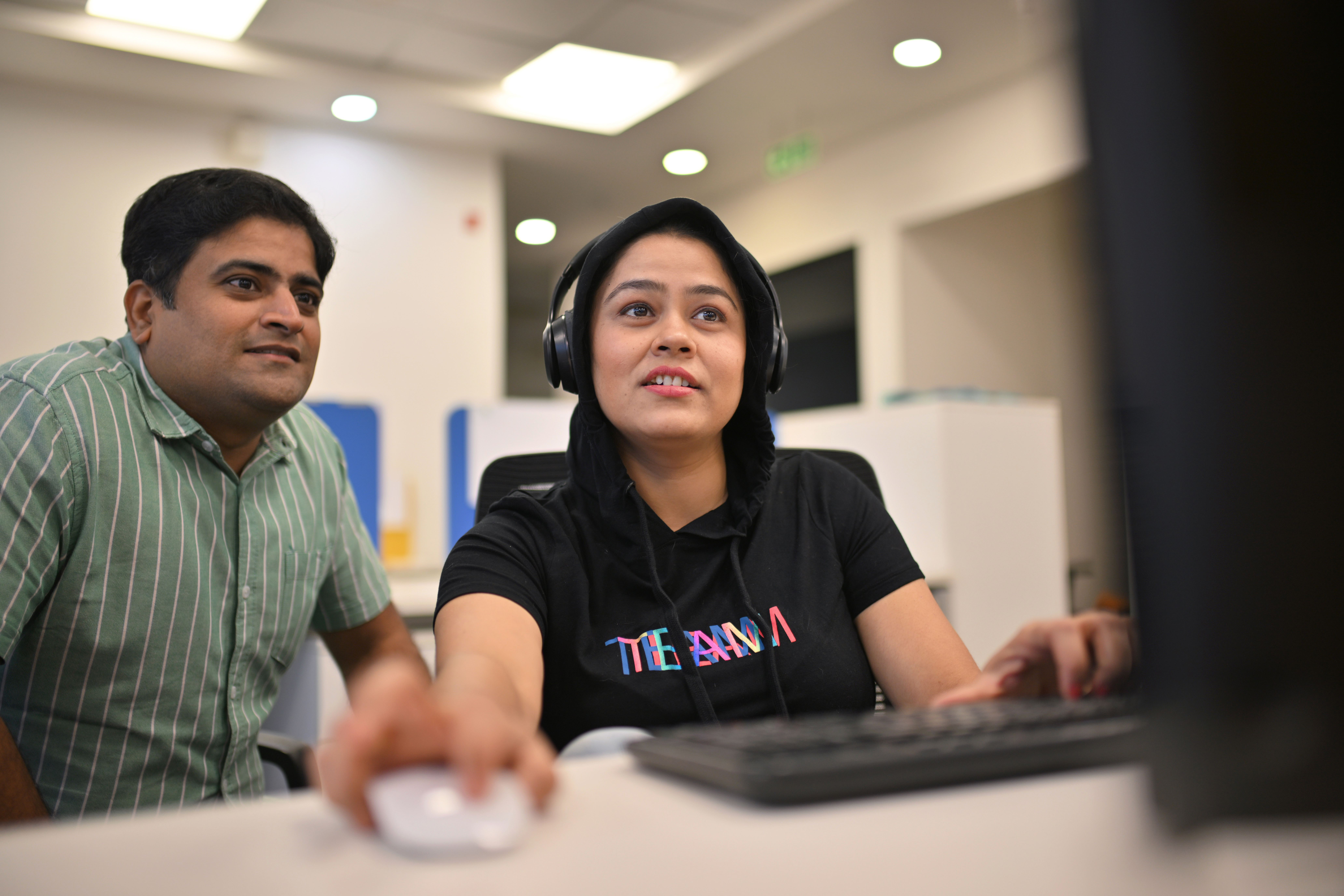 Co-workers working together in the office cubicle