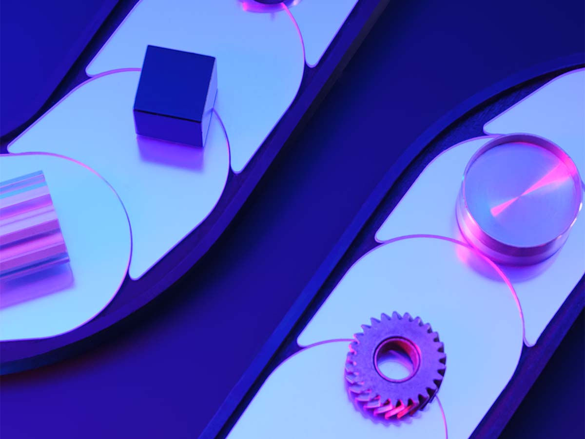 An abstract composition featuring mechanical shapes, including a gear and a cube, on a blue and purple industrial-themed background with reflective surfaces and vibrant lighting.