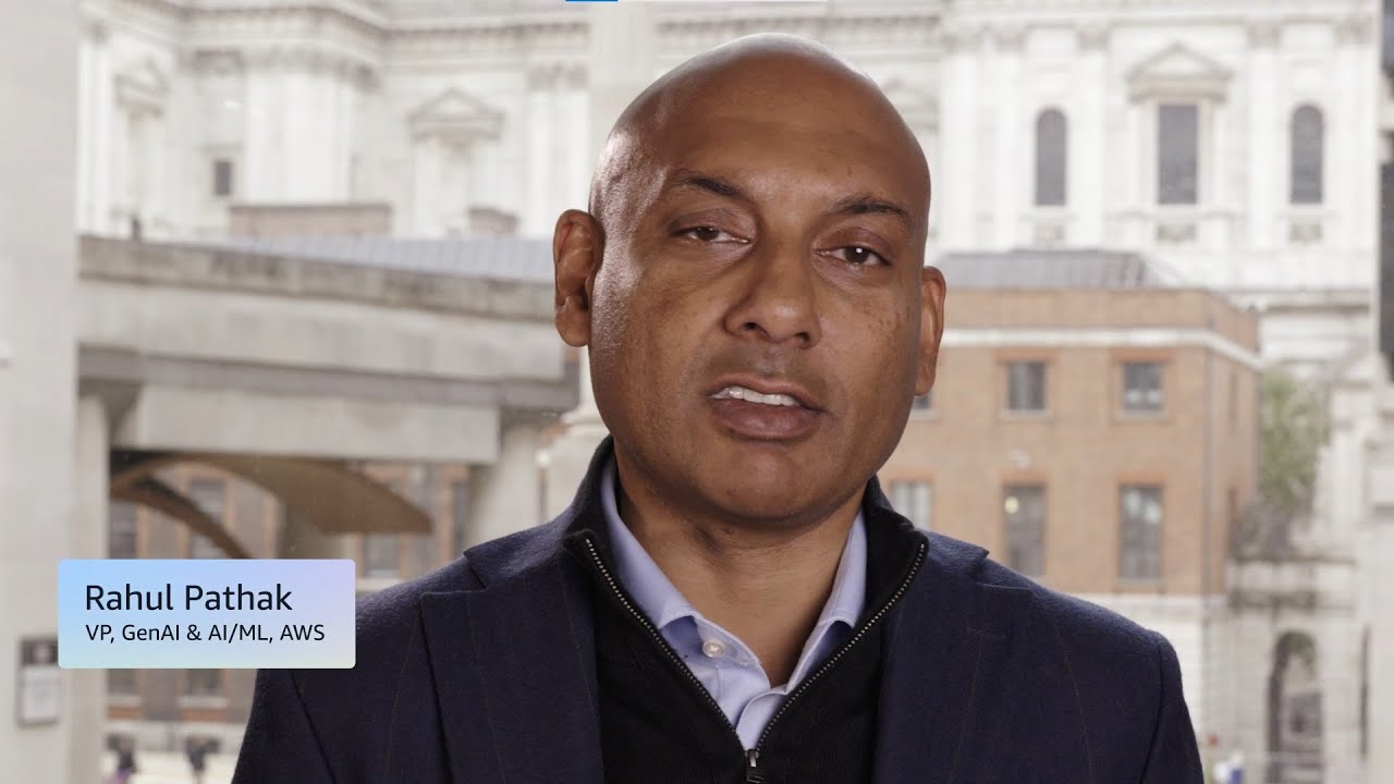 Text overlay reads "Rahul Pathak, VP, GenAI & AI/ML, AWS" with a blurred background of classical architecture.