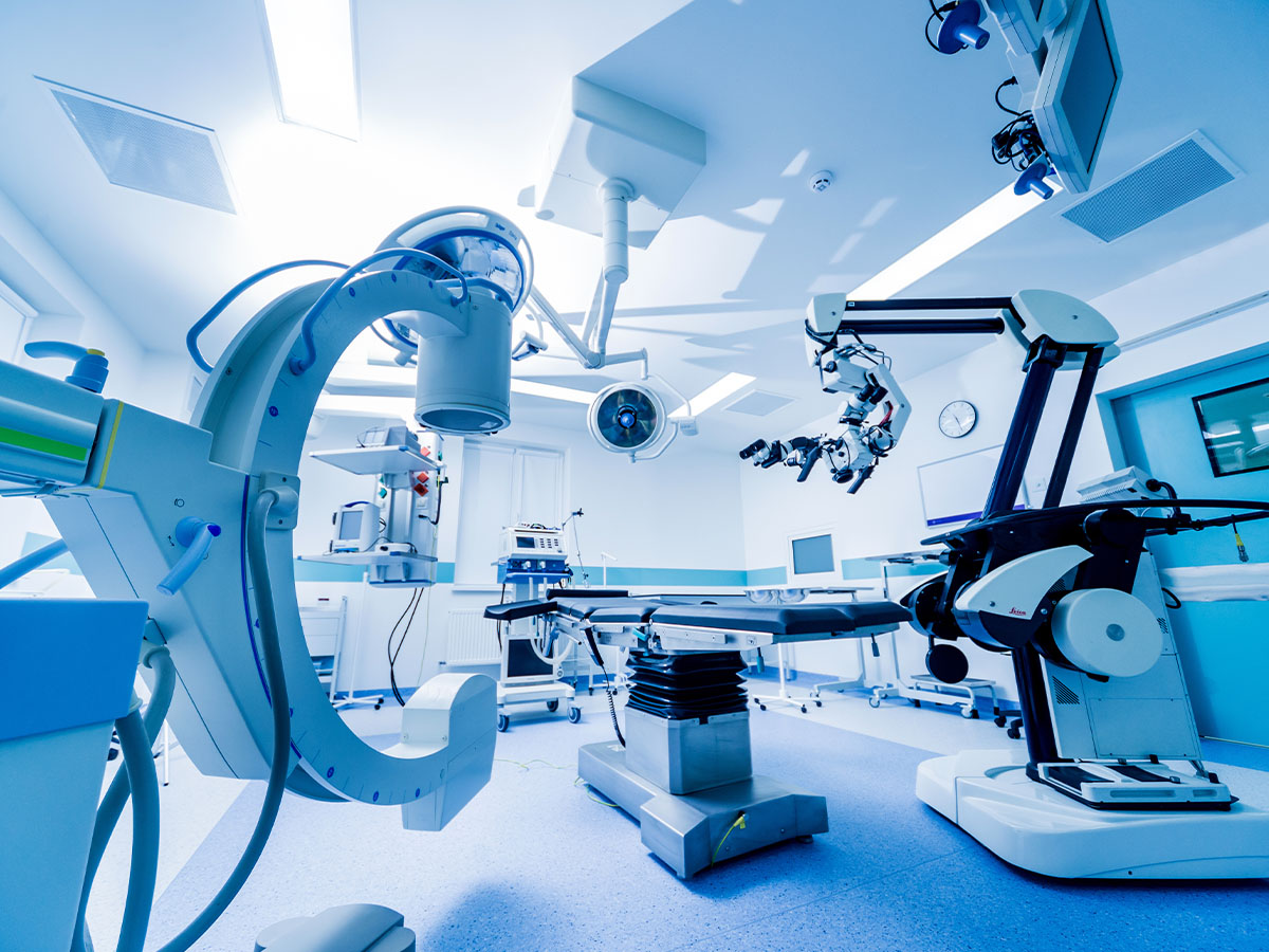 Modern operating room with advanced robotic surgical equipment and medical devices.
