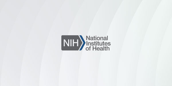 The logo of the National Institutes of Health (NIH) displayed on a light background with subtle curved lines.
