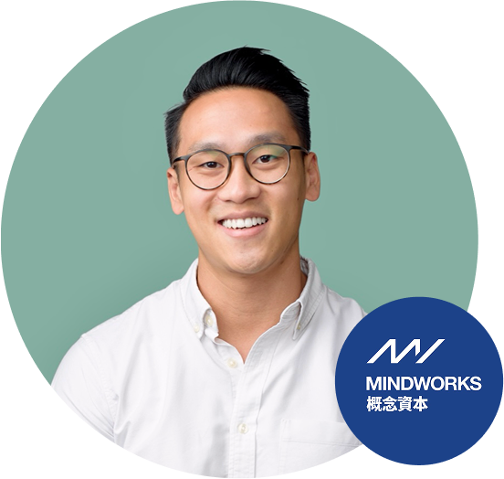 Portrait of a man wearing glasses and a white shirt on a green background, with the MindWorks logo in the lower right corner.