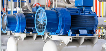 Close-up of industrial blue electric motors mounted on machinery in a factory setting.