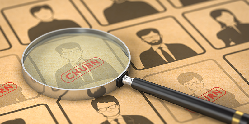 Illustration showing a magnifying glass highlighting a person with the word 'CHURN' among a group of customer profile icons, representing customer churn analysis.