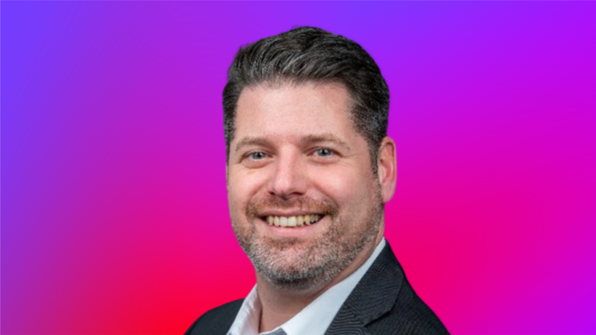 A person in a suit against a vibrant gradient background transitioning from purple to pink.