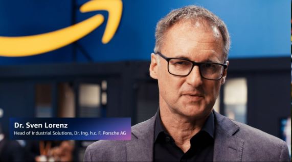 Dr. Sven Lorenz, Head of Industrial Solutions at Porsche AG, speaks in front of an Amazon Web Services backdrop.