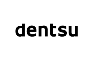 The image shows the Dentsu company logo, consisting of the word 'dentsu' in bold black lowercase letters on a white background.
