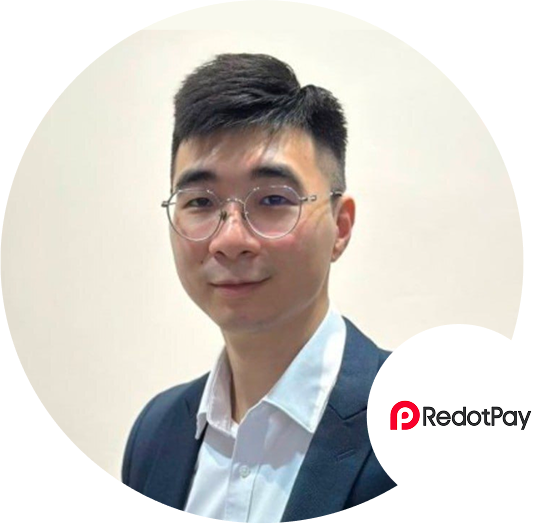 Profile portrait of a man wearing a suit and glasses, with the RedotPay logo visible in the corner.