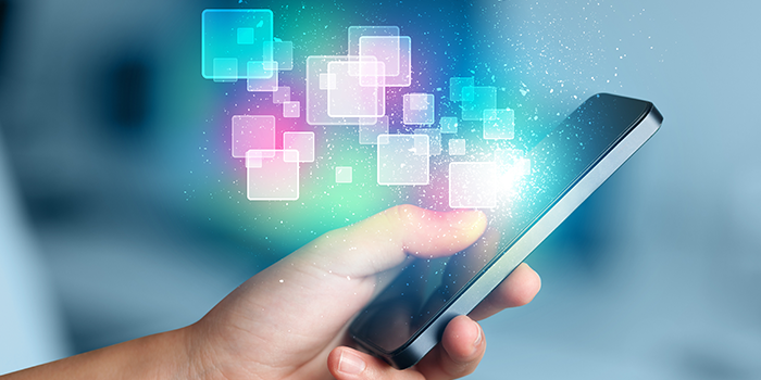 A hand holding a smartphone with glowing, colorful digital squares and sparkles emerging from the screen, representing mobile technology and digital analytics.
