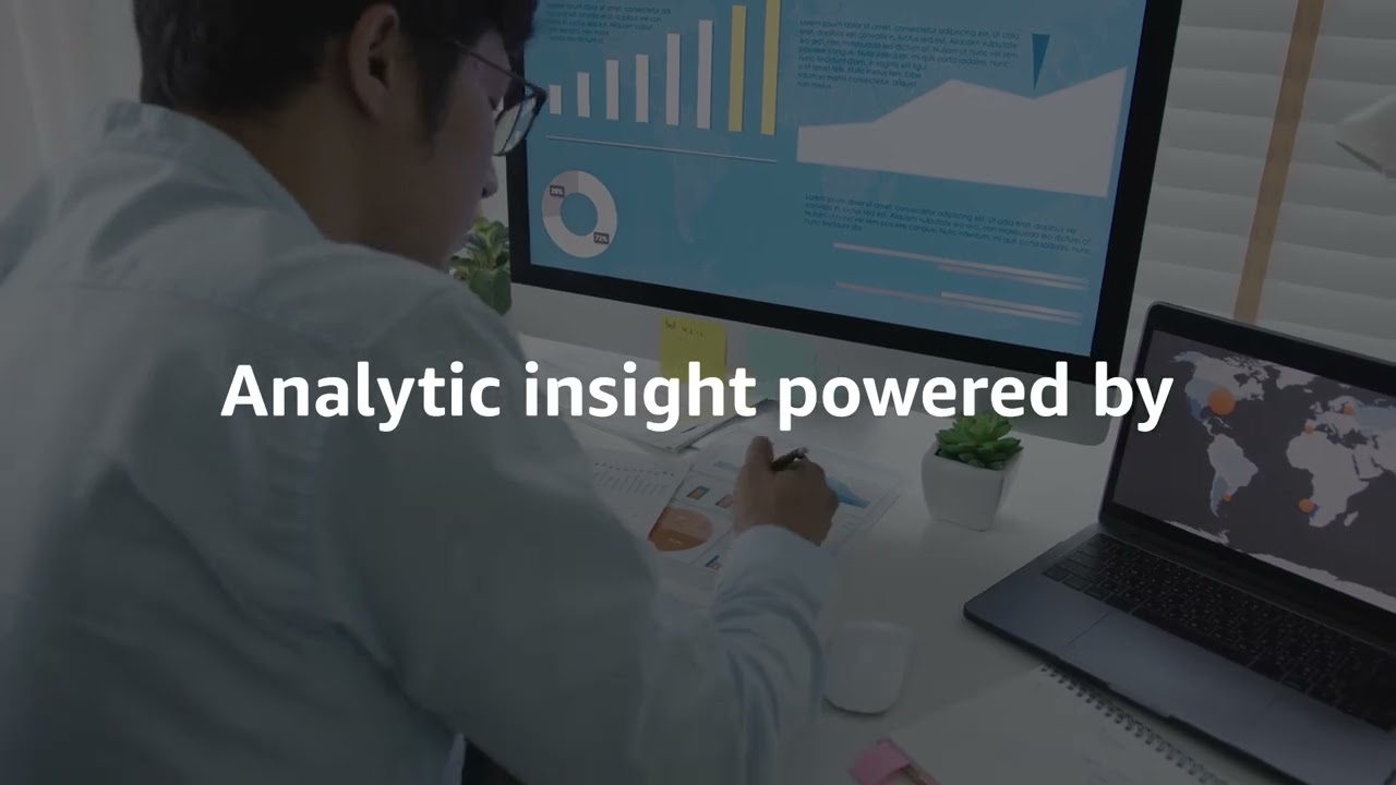 A person analyzing data at a desk with charts, graphs, and world map visualizations on computer screens. The text 'Analytic insight powered by' is displayed prominently, representing data analytics and insight generation.