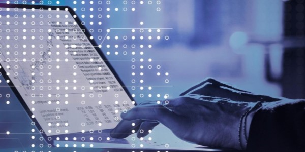 A person using a laptop with data and charts on the screen, overlaid with a digital pattern of dots and lines.