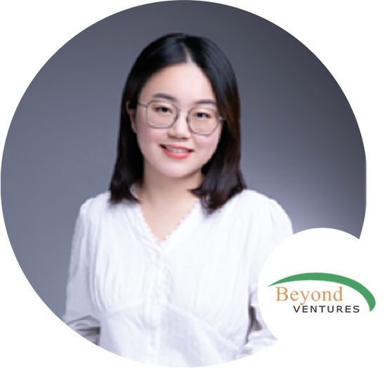 A woman in a white blouse with glasses posing for a professional profile photo, with the Beyond Ventures logo in the corner.