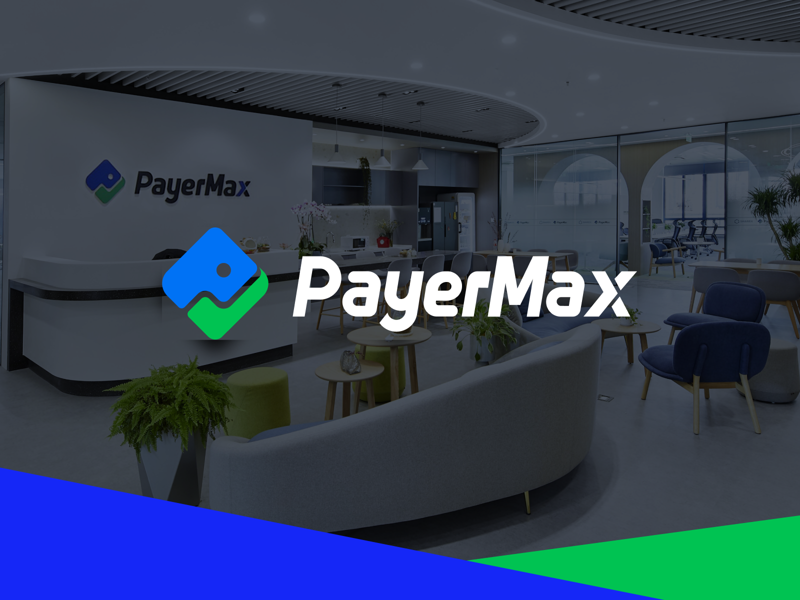 Modern office space with PayerMax branding displayed prominently, featuring sleek furniture and a reception desk.