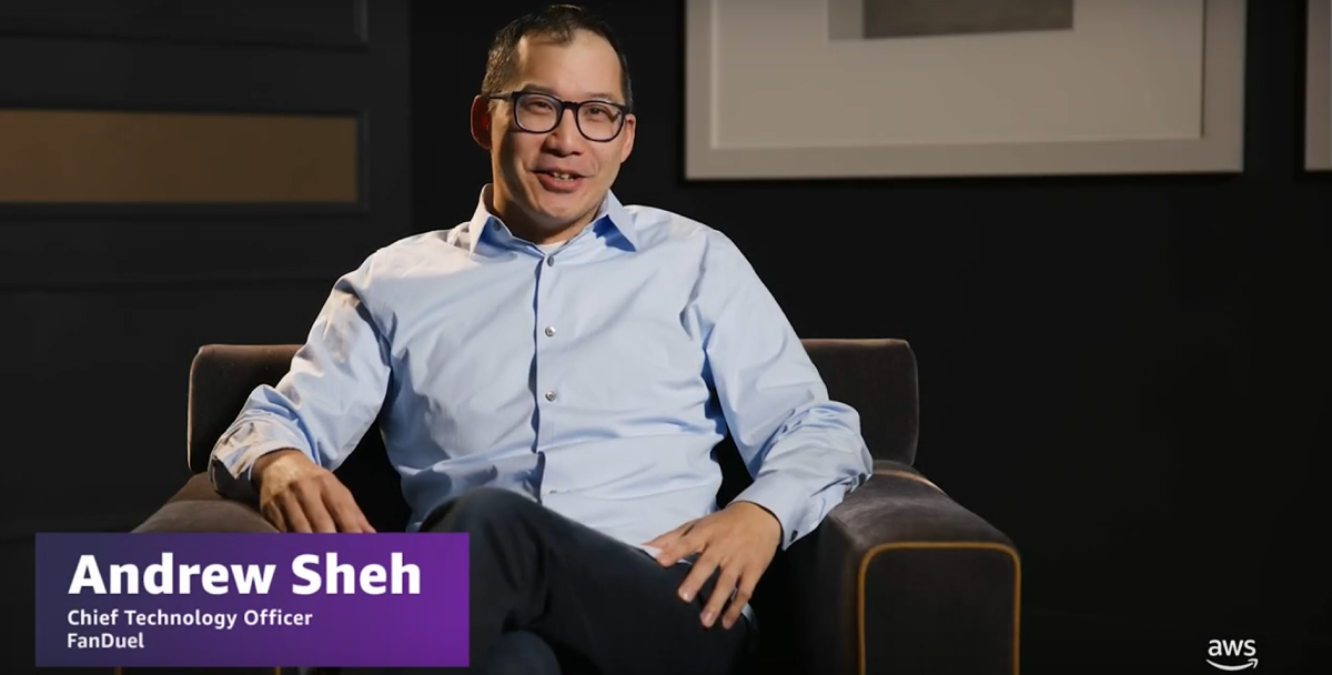 Andrew Sheh, Chief Technology Officer at FanDuel, sitting in a chair with a dark background and a name/title overlay.