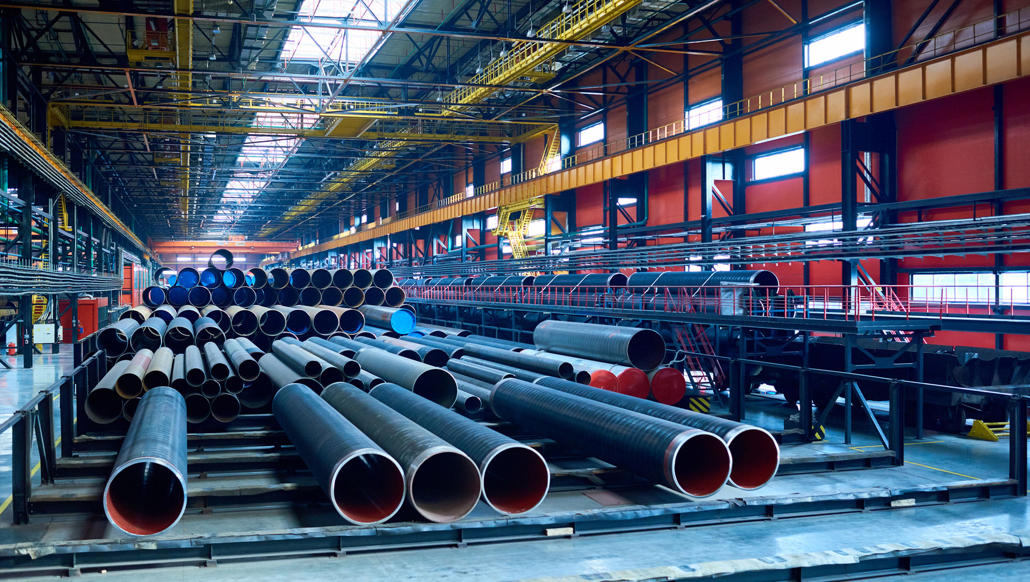 Abundance of tubes used for oil and gas industry placed in factory warehouse