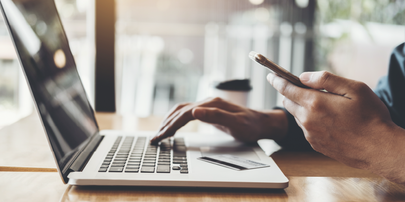 Man with phone and laptop