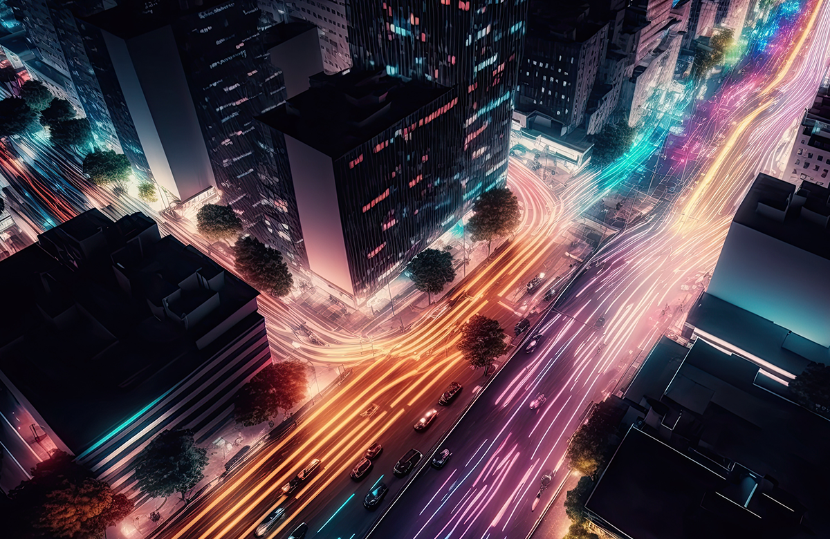 A high-angle view of a city at night with illuminated buildings and vibrant light trails from vehicles, symbolizing high-speed computing and data flow.