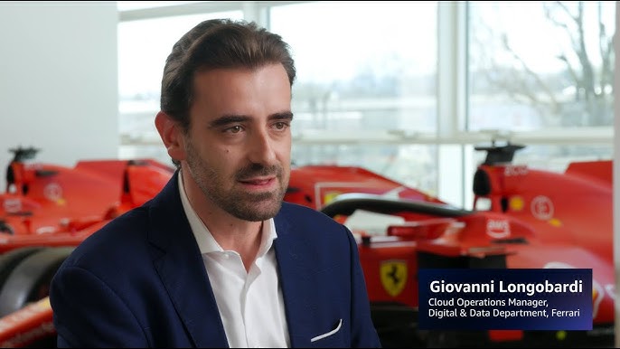 Thumbnail image featuring a Ferrari executive with Formula 1 cars in the background, representing a video case study on AWS industrial data solutions for Ferrari.