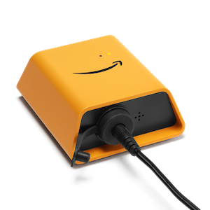 A small orange device with the Amazon smile logo, featuring a power cord plugged into the back.