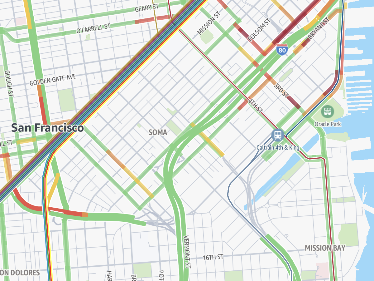 A top-down view of a city map with roads overlayed by green lines representing good traffic and a section of red indicating bad traffic. 