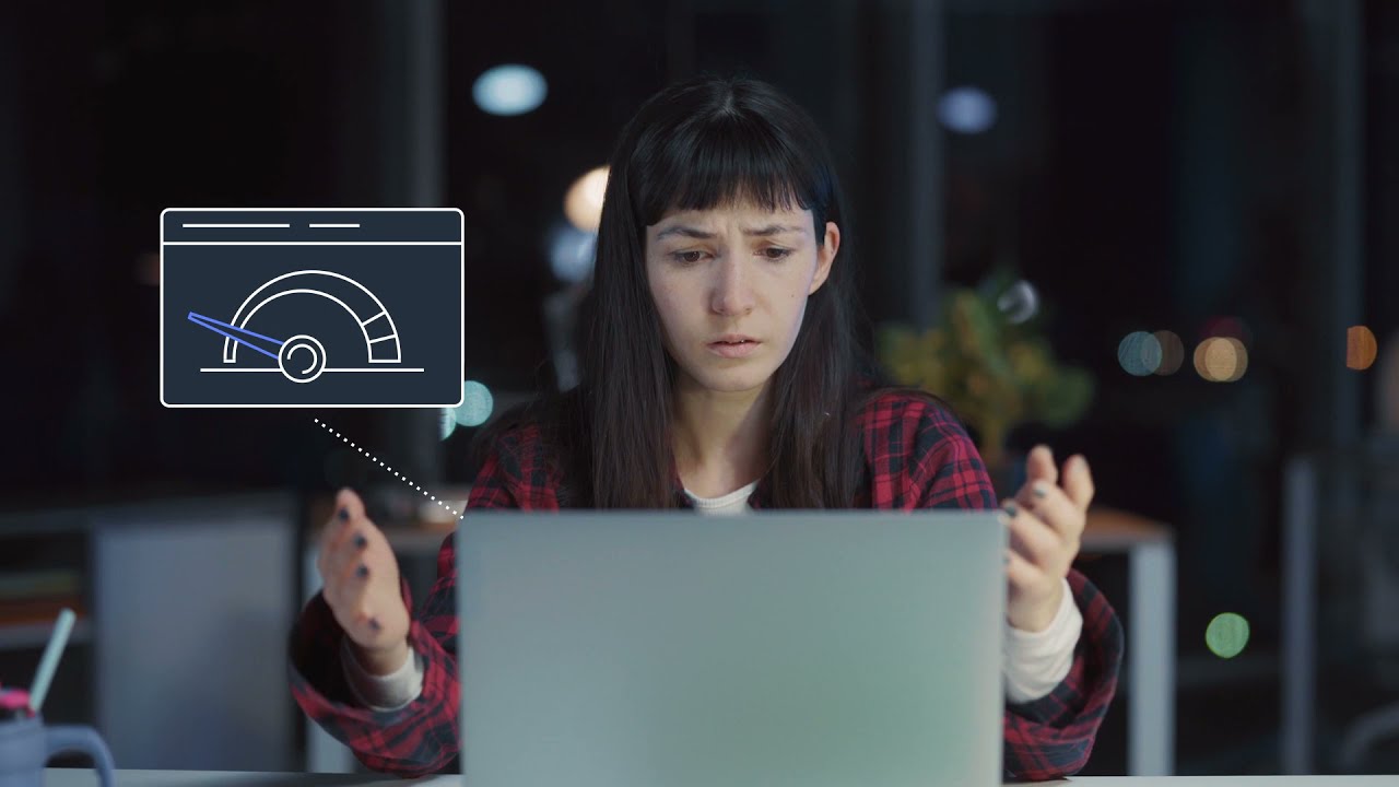 A woman sits in front of her laptop looking frustrated, with a digital graphic overlay showing a slow internet speed indicator. The image conveys an experience of frustration due to slow internet connectivity.
