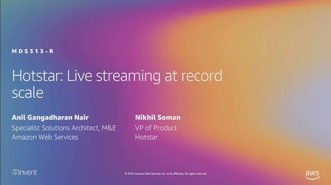 Slide from an AWS re:Invent presentation titled 'Hotstar: Live streaming at record scale' featuring Anil Gangadharan Nair, Specialist Solutions Architect, Media & Entertainment at Amazon Web Services, and Nikhil Soman, VP of Product at Hotstar. The slide features a colorful gradient background.