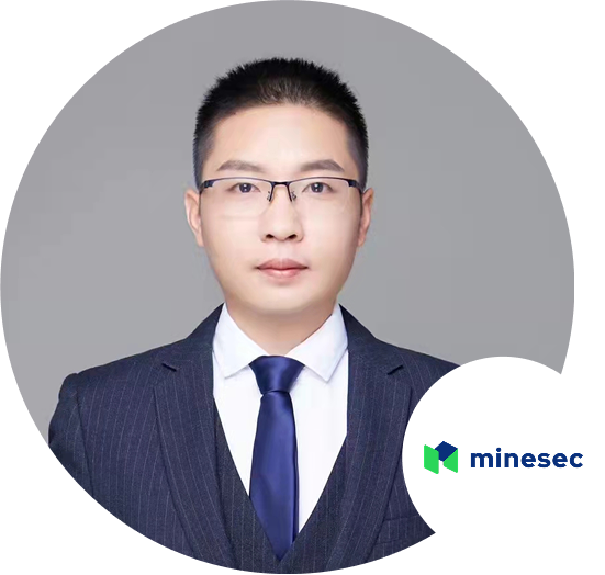 Formal portrait of a man wearing a suit, tie, and glasses, with the Minesec logo in the corner.