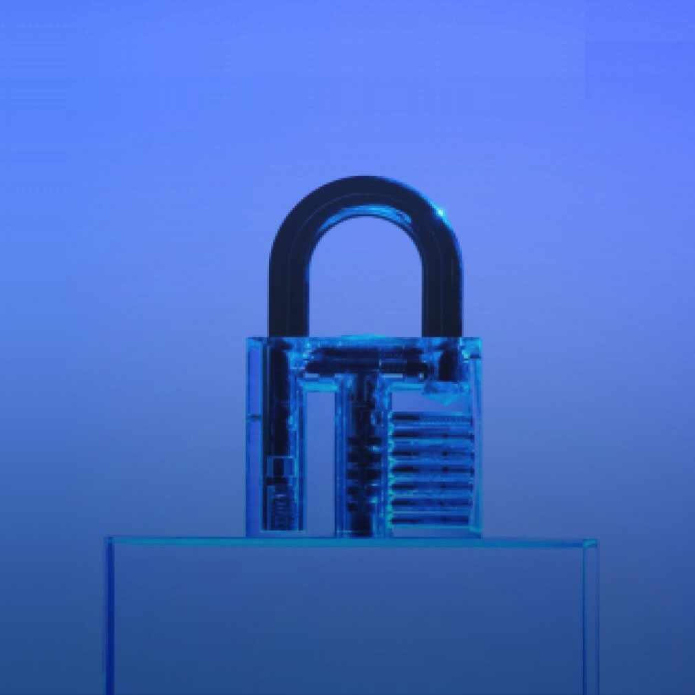 A close-up image of a transparent padlock set against a blue background, symbolizing security, data protection, and identity compliance.