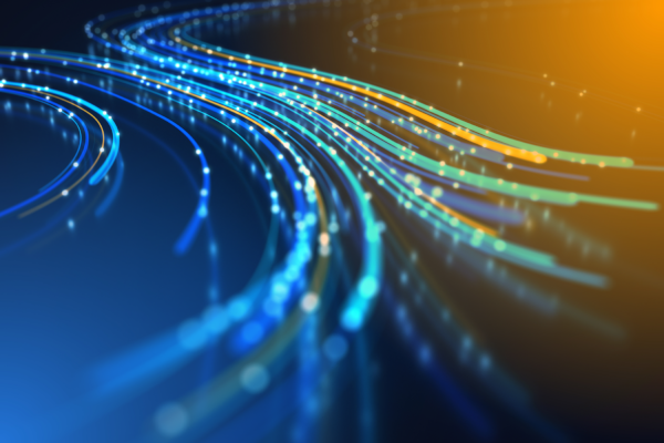 Glowing blue and orange light trails curving across a dark background, resembling data streams or fiber optics.