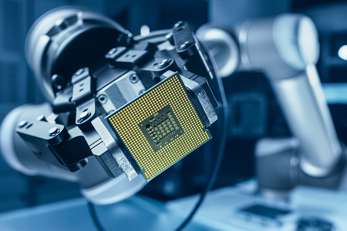 A robotic arm precisely holding a microchip, representing advanced automation and technology in electronics or semiconductor manufacturing.