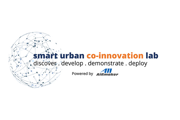 Alt-text: "Smart Urban Co-Innovation Lab logo with tagline 'discover, develop, demonstrate, deploy,' powered by AIRmaker, featuring a connected network globe design."