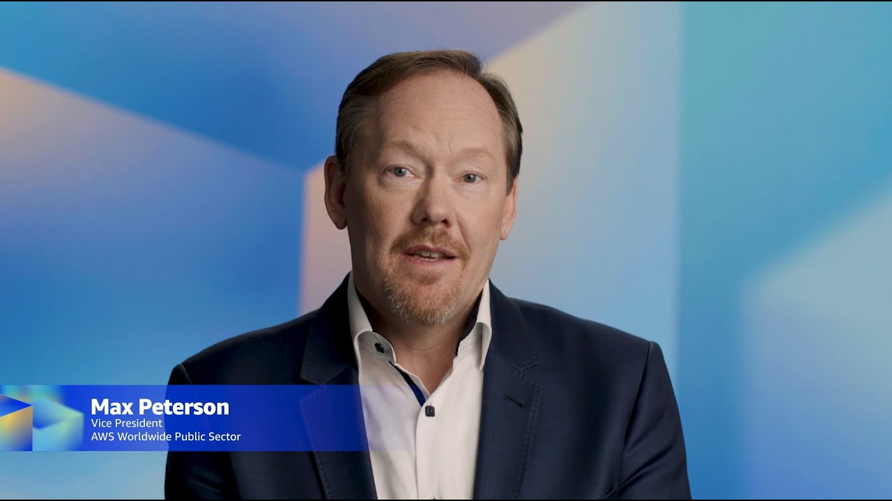 Text overlay reads "Max Peterson, Vice President, AWS Worldwide Public Sector" against a blue gradient background.