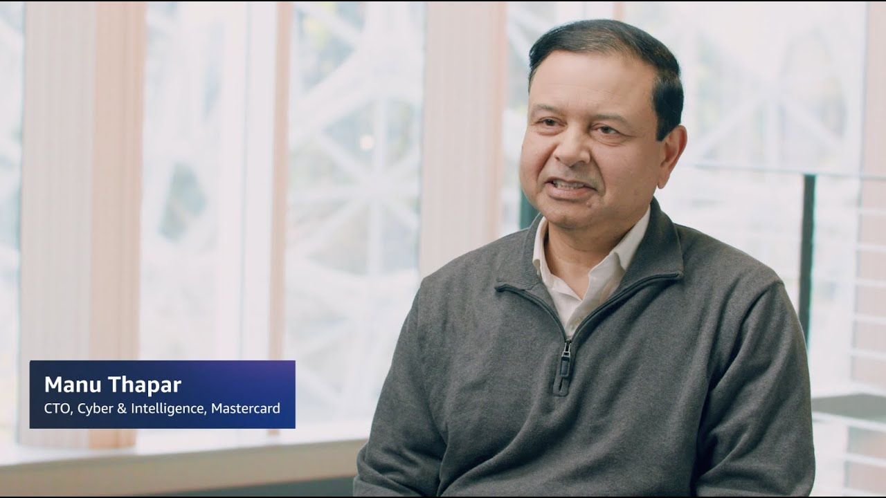 YouTube thumbnail image showing Manu Thapar, CTO of Cyber & Intelligence at Mastercard, during an interview.