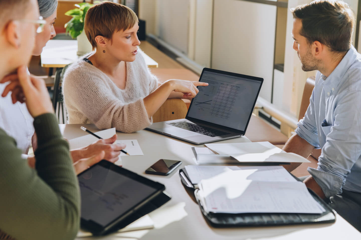 Business leaders reviewing financial predictions on laptop screen