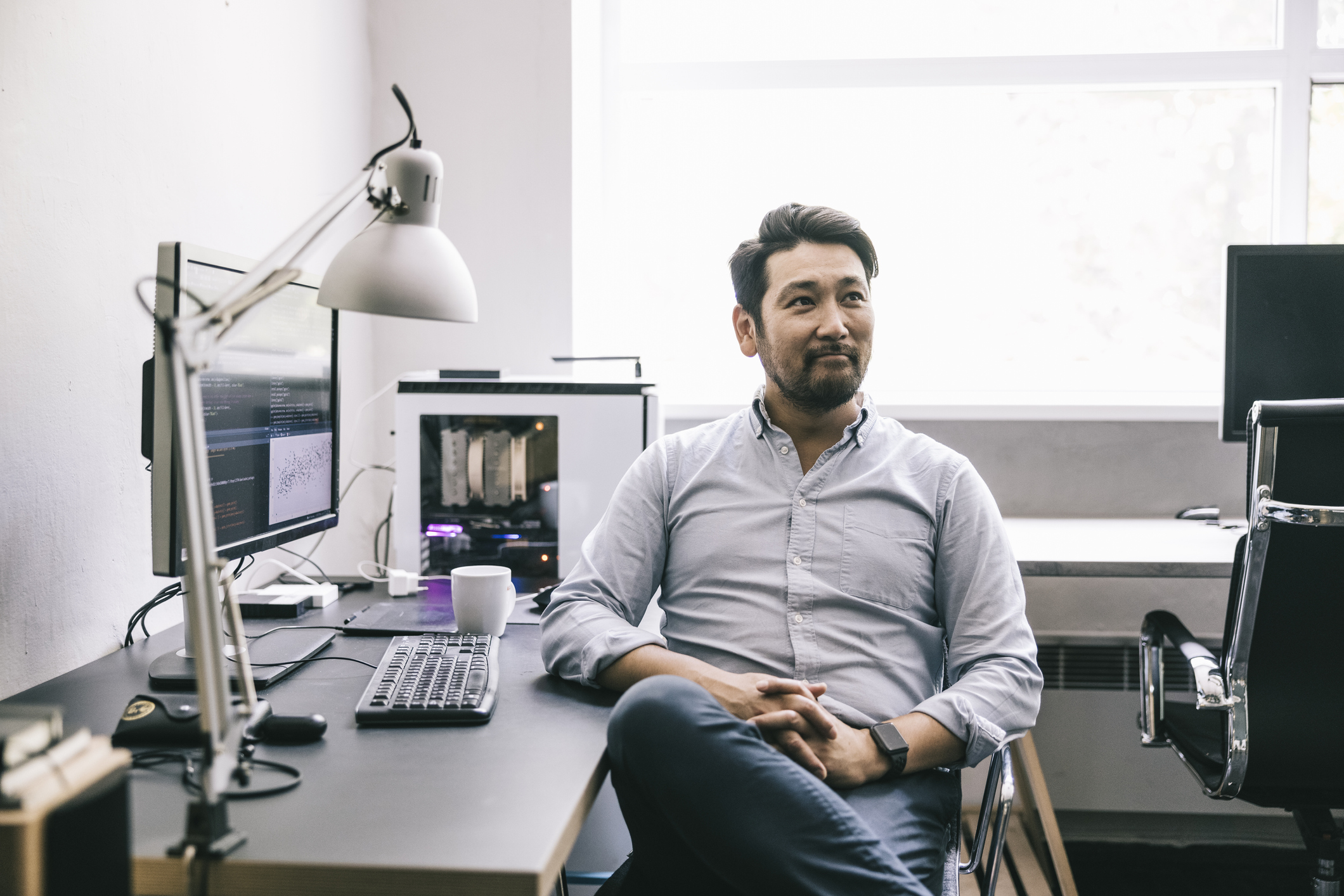 Candid portrait of male programmer at work.