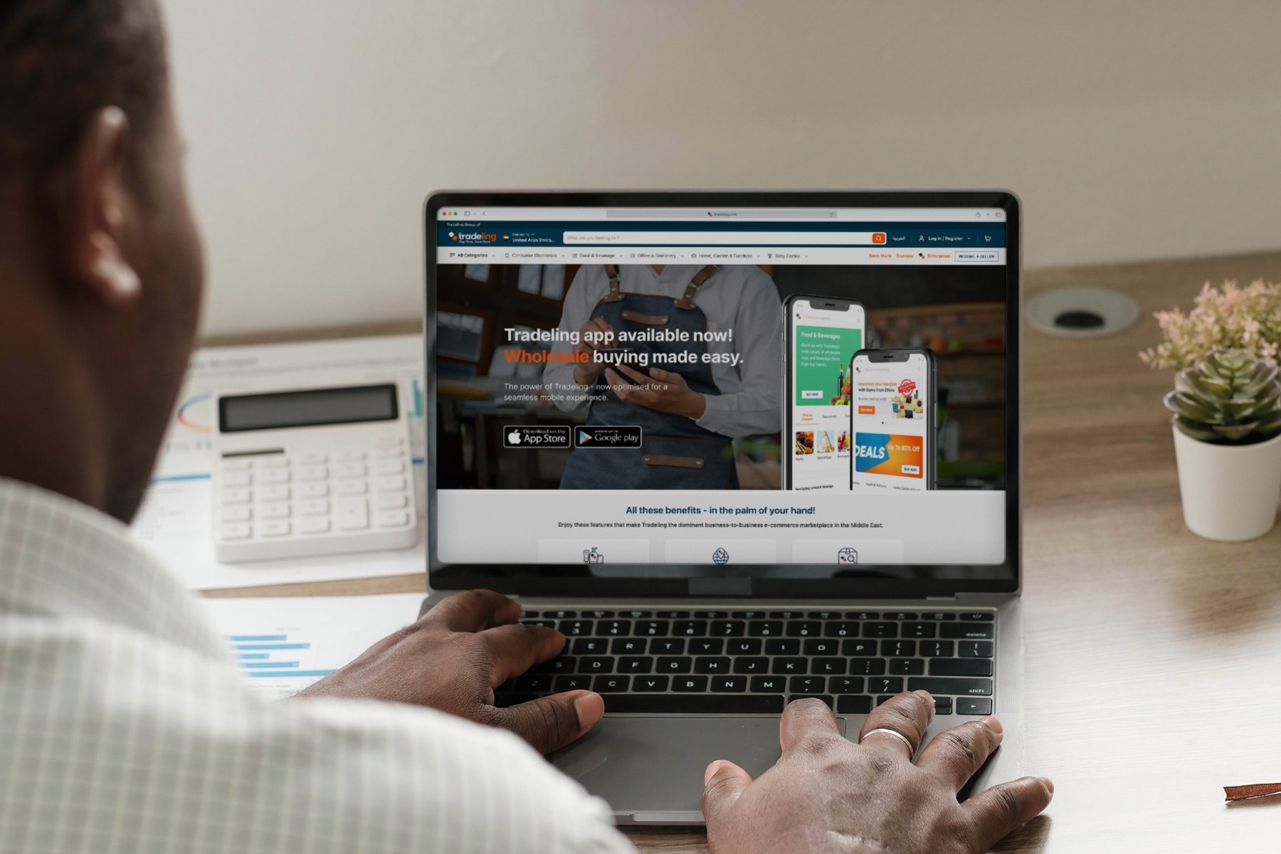 Person in an office using a laptop to visit Tradeling website