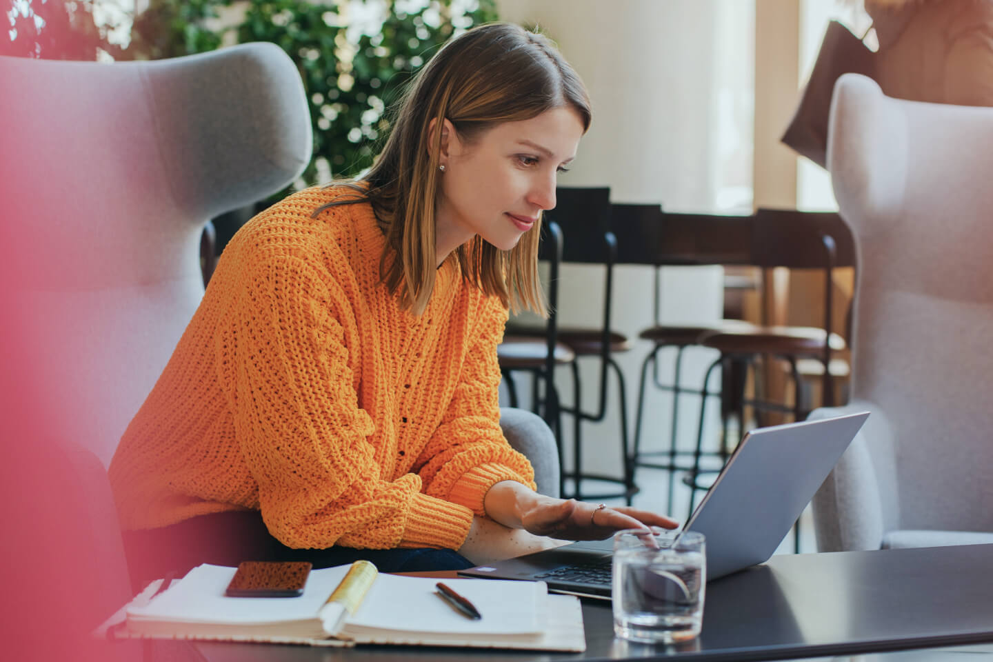 Remote working business leader accessing company work computer in a loung chair off premises