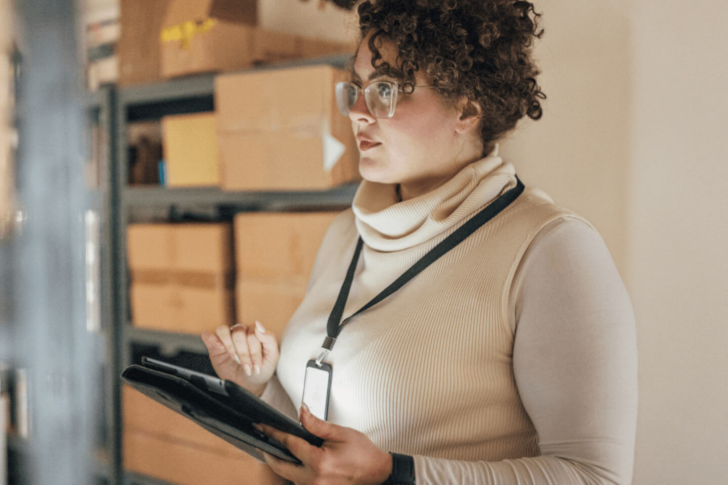 Small business owner holding tablet in warehouse