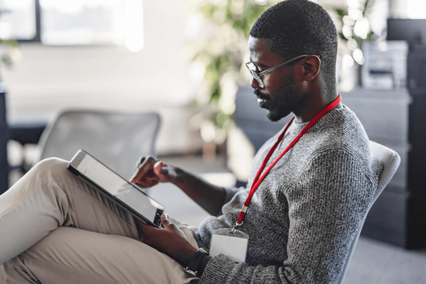 Technical decision maker sat using a touch screen tablet