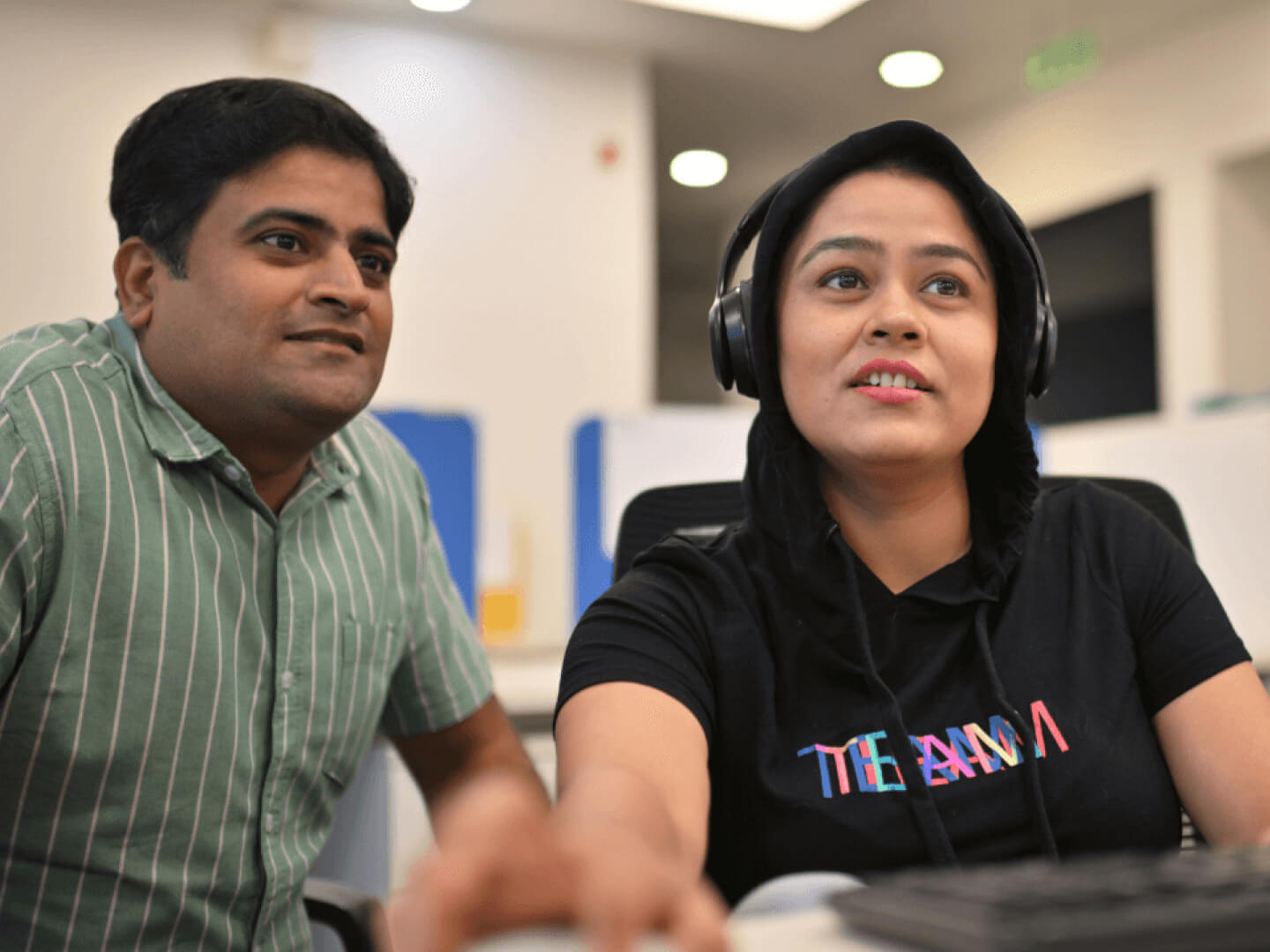 Technical experts looking at a computer screen